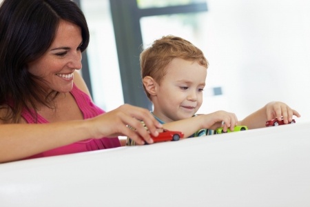 mom and son playing with toy cars