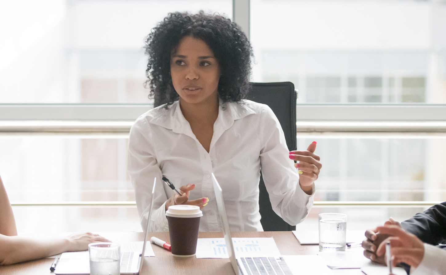 female executive at head of the table during a meeting