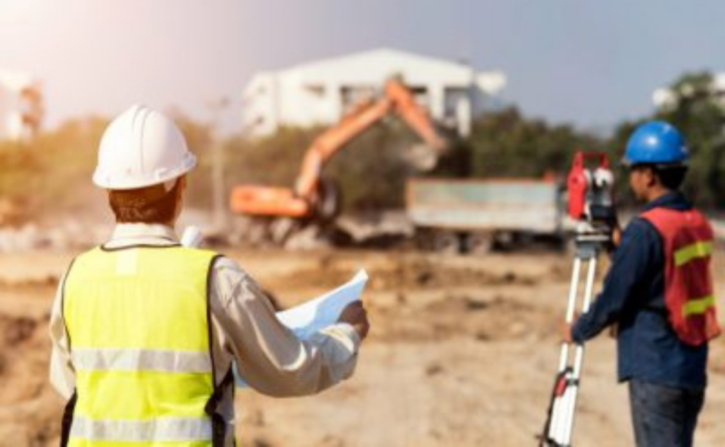 contractor looking at plans on a worksite