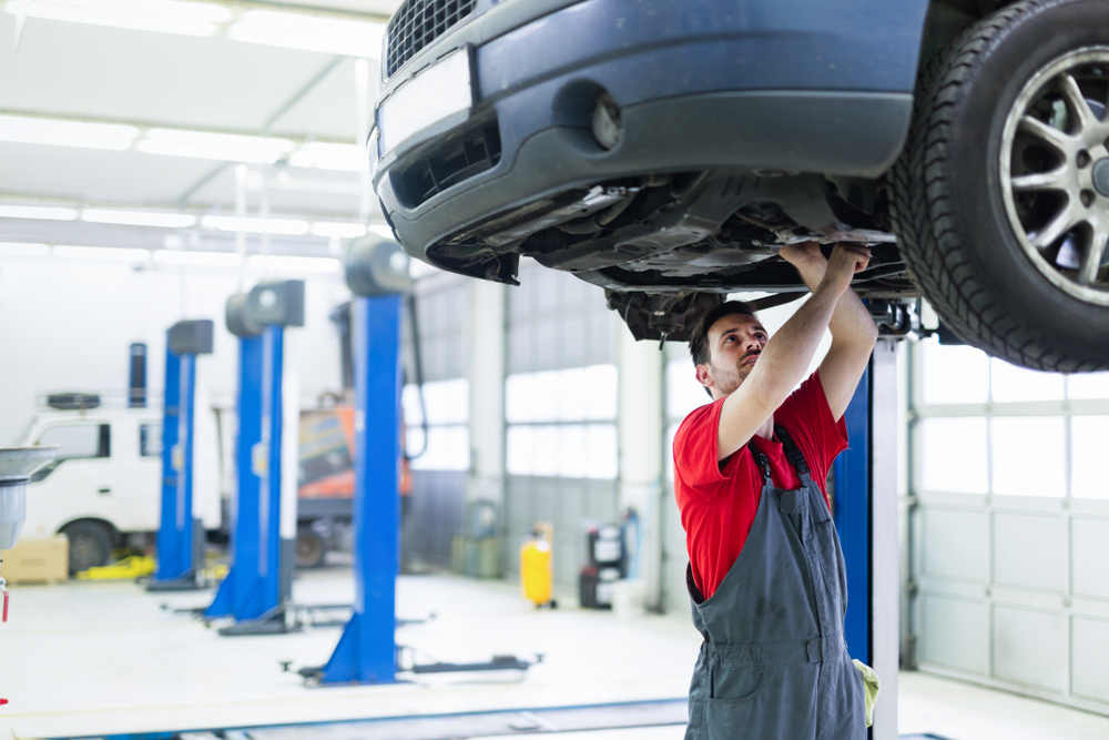 mechanic working under a lifted car