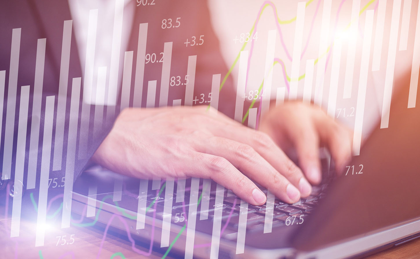 man's hands typing on a computer with numbers