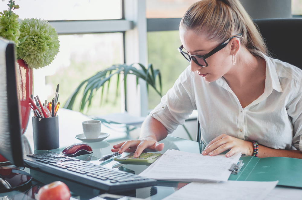 businesswoman working on calculator